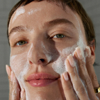ダーマロジカ デイリーマイクロフォリエント 使用イメージ — 泡を顔全体になじませる女性のクローズアップ | 酵素洗顔パウダー